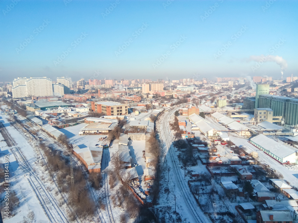 Winter town. Frosty sunny day in the city. Snow on the streets and smoke from the boiler rises. Frost and sun, a wonderful day