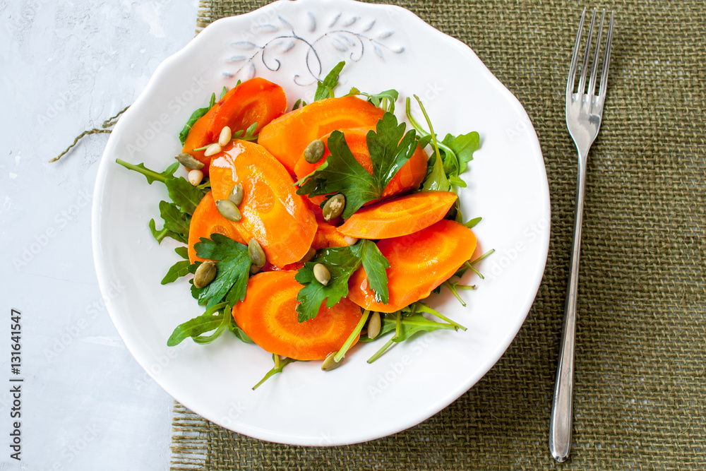 Simple salad of baked carrots with arugula and butter. Vegan healthy lunch or dinner. Simple salad of baked carrots with arugula and butter. Vegan healthy lunch or dinner.