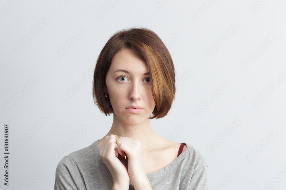 Timid and girl shyly looking ahead, clenched hands into fists Timid and girl shyly looking ahead, clenched hands into fists