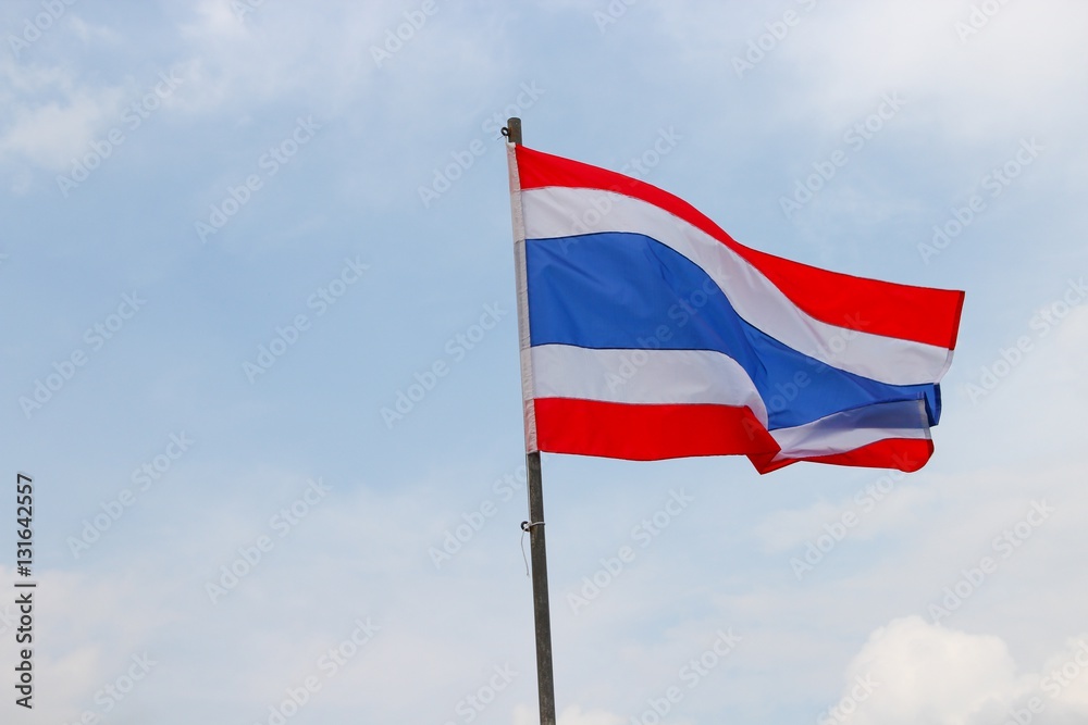 Thai flag, waving in the wind with beautiful with blue sky background Thai flag, waving in the wind with beautiful with blue sky background