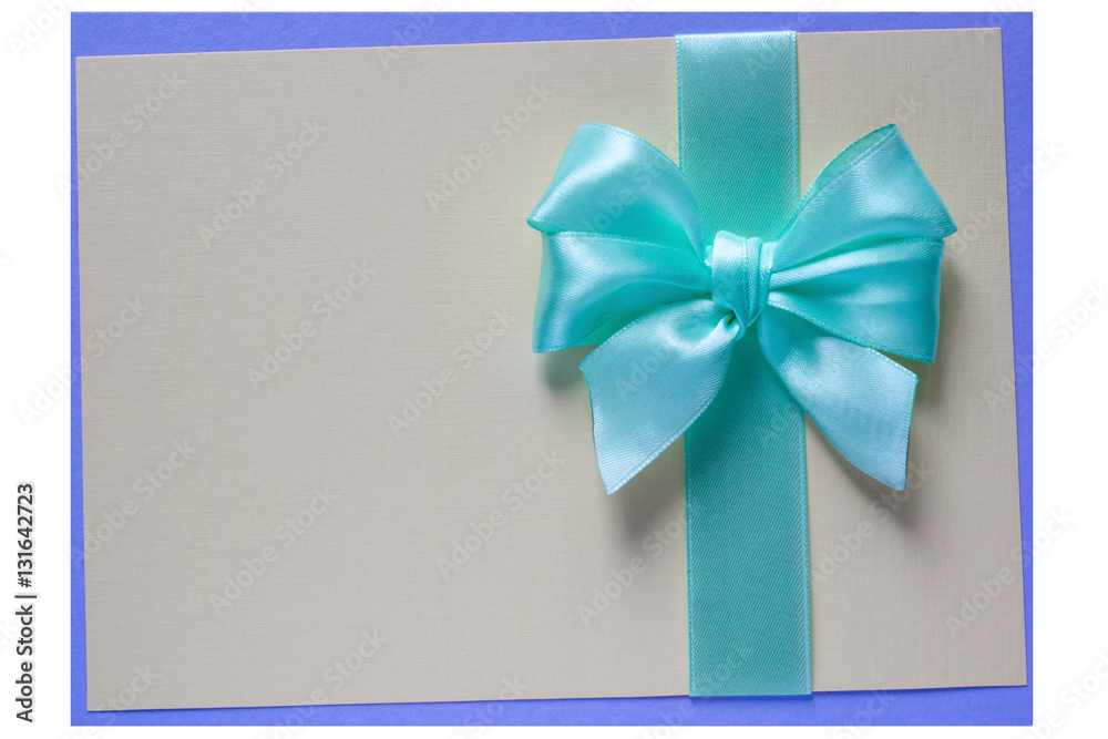 Turquoise bow and ribbon on card Turquoise bow and ribbon on card