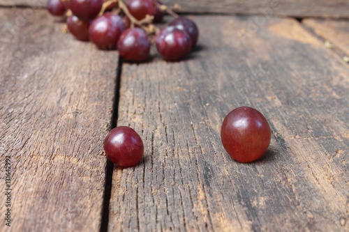 Grape red fresh Select focus with shallow depth of field on wooden table background © pramot48