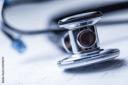Stethoscope on a heart monitor printout.Electrocardiogram chart and stethoscope.