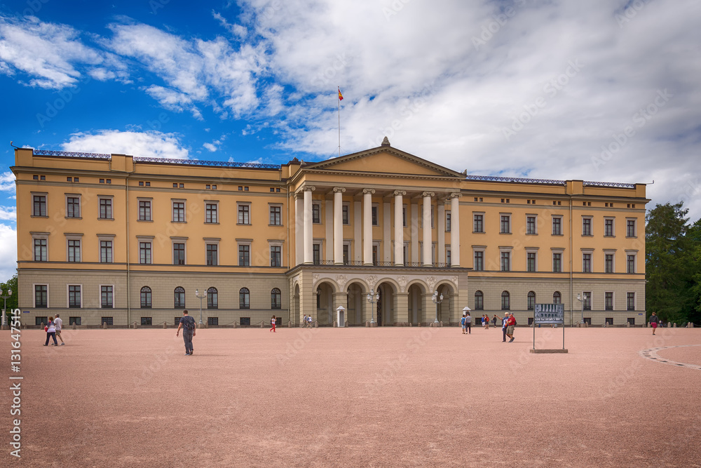 Oslo, Norway - July 18, 2016: View of the Slottet, the Royal Palace in Oslo in sunny daylight. The image is shot inside the square in front of it during a beautiful day with an huge blue sky.