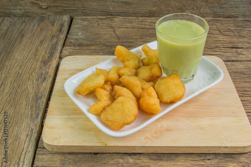 green soybean milk and deep-fried doughstick on wood background
