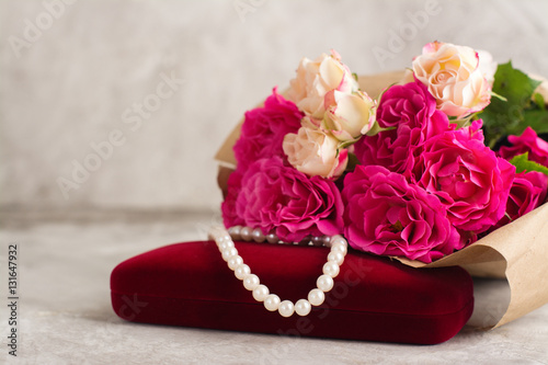 Pearl necklace and roses bouquet