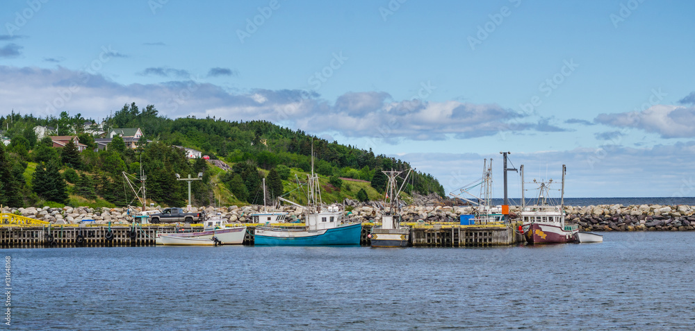 Bonavista, Newfoundland fishing villages.   Boats tied up for the day on calm coastal water. 
