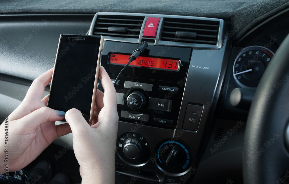 Hand hold smartphone in car,People press the phone while driving Hand hold smartphone in car,People press the phone while driving