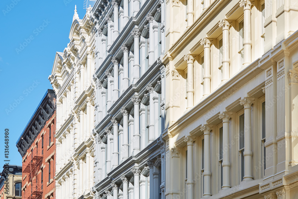 Ancient houses facades in New York, sunny day and blue sky, Soho