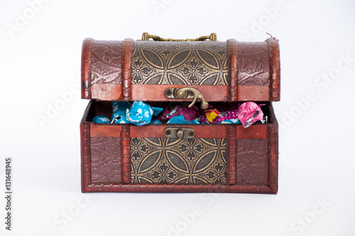 Treasure box chest full of bonbons, half opened