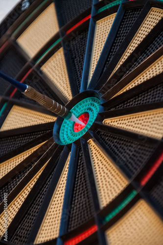 Colorful dart and target with green, yellow and red colors at th