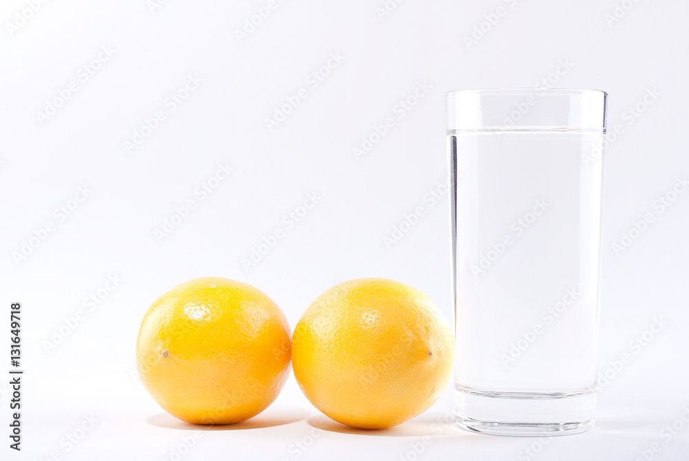 glass of water with lemon on a white background glass of water with lemon on a white background
