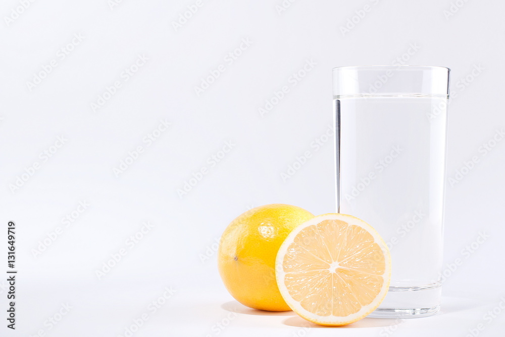 glass of water with lemon on a white background glass of water with lemon on a white background