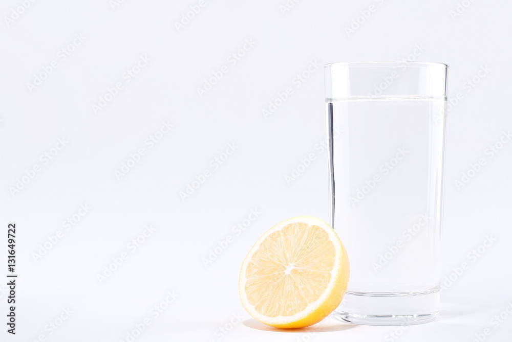 glass of water with lemon on a white background glass of water with lemon on a white background
