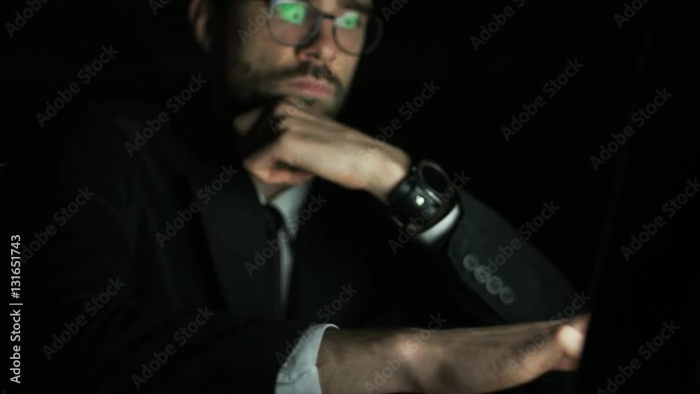 Young Businessman Using a Laptop Computer Young Businessman Using a Laptop Computer