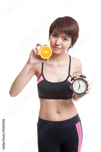 Beautiful Asian healthy girl with orange and clock.