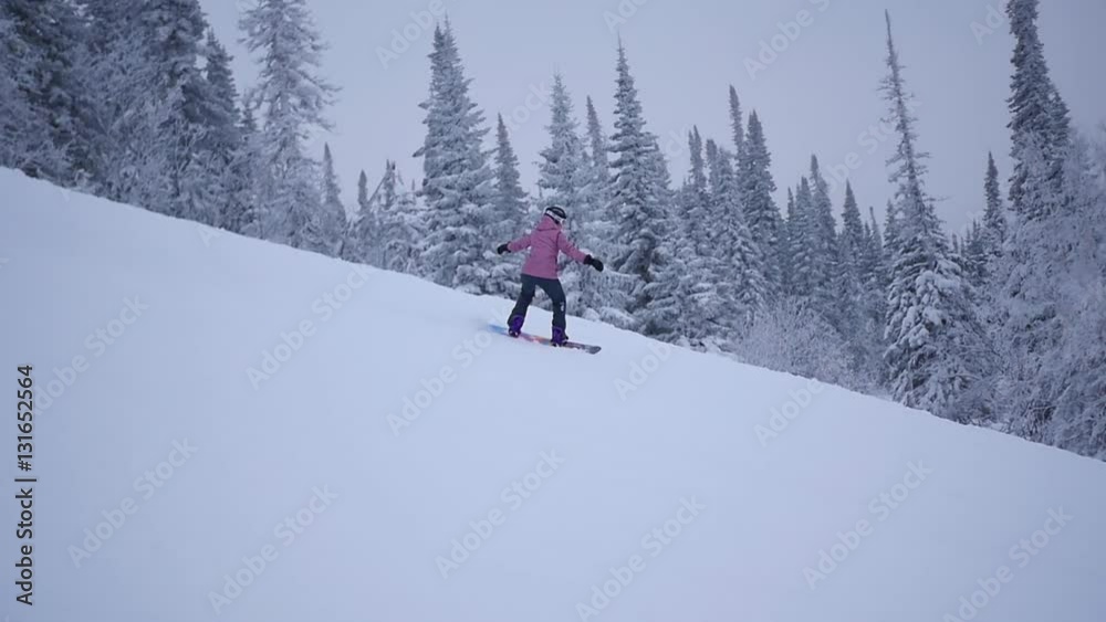 the girl descends from the mountain on snowboard in slowmo the girl descends from the mountain on snowboard in slowmo