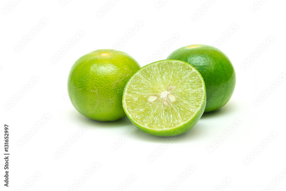 Limes and a half cut with seeds inside on isolated white background. Limes and a half cut with seeds inside on isolated white background.