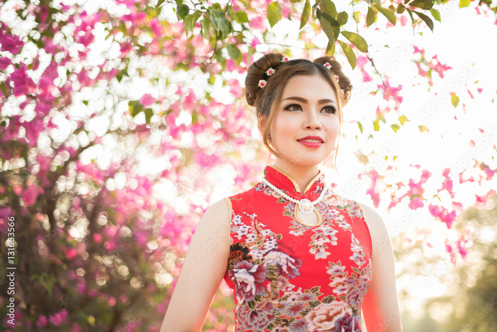 Smiling Chinese woman dress traditional cheongsam at New Year Smiling Chinese woman dress traditional cheongsam at New Year