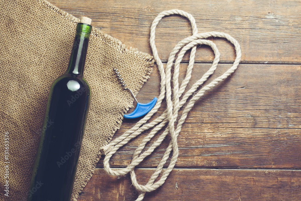 Wine  and corkscrew on the wooden background.