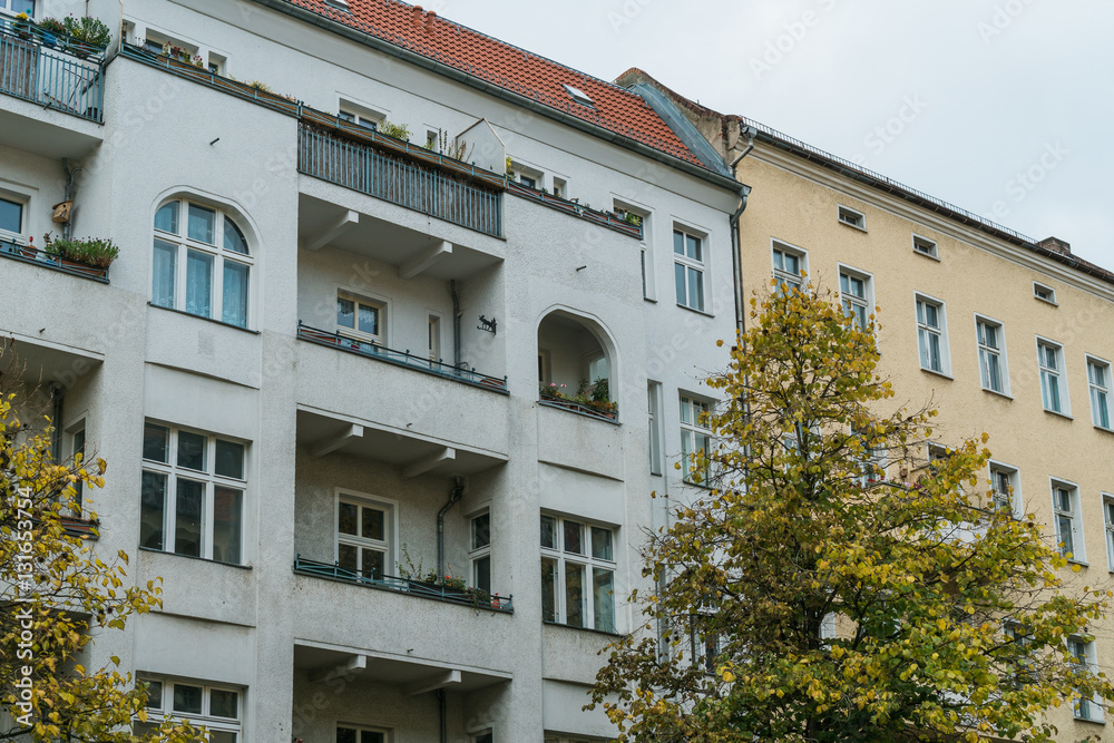 yellow and white buildings with big balconies