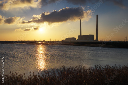 Beautifull landscape with thermal power plant, lake and sunset sky