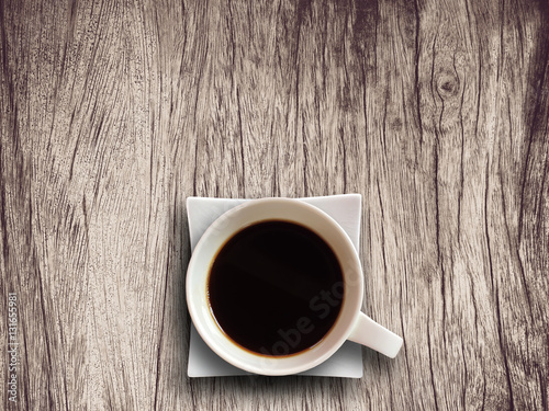 Coffee cup on wooden table background textured.