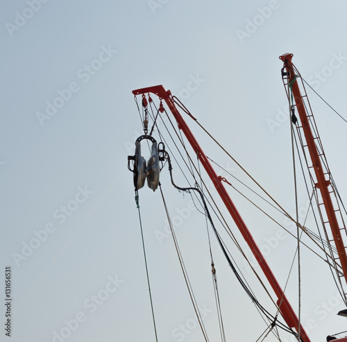 Pulley and ropes on a fisherboat with the sky background photo