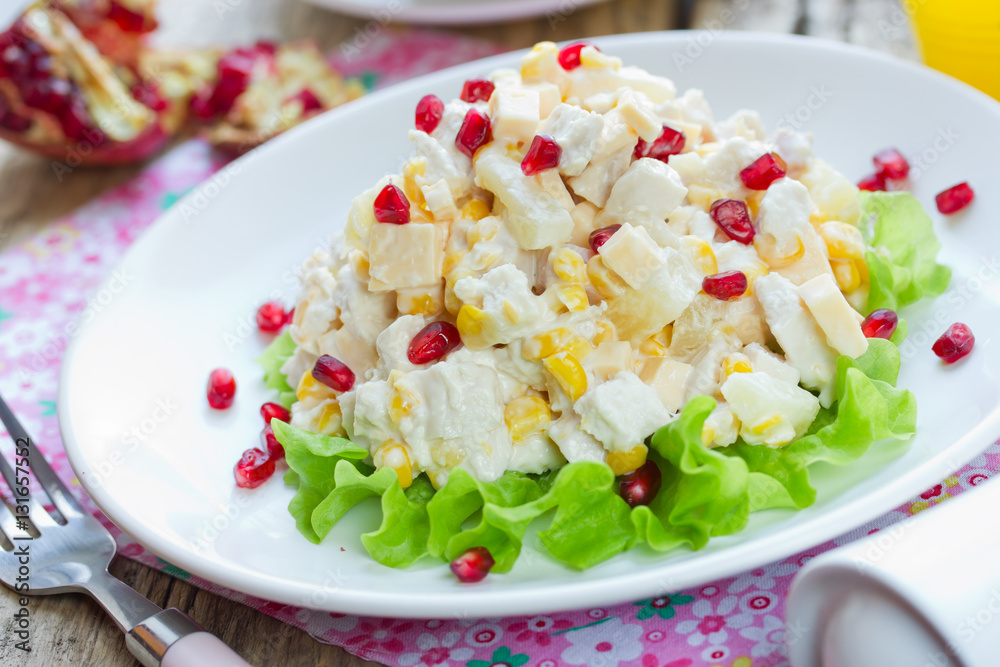 Delicious festive salad with chicken breast, corn, cheese, pineapple and pomegranate Delicious festive salad with chicken breast, corn, cheese, pineapple and pomegranate