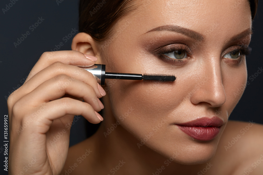 Beauty Woman Makeup. Beautiful Woman Applying Black Mascara