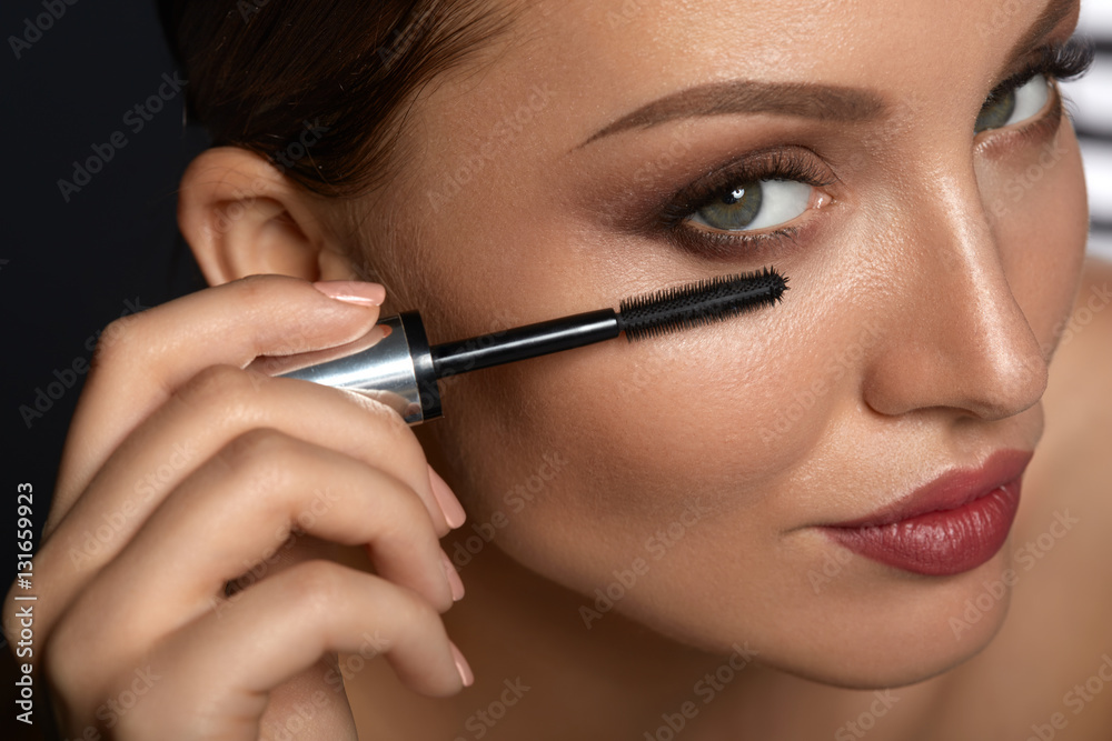 Beauty Woman Makeup. Beautiful Woman Applying Black Mascara