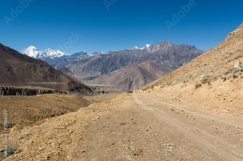 Desert road towards mountains.