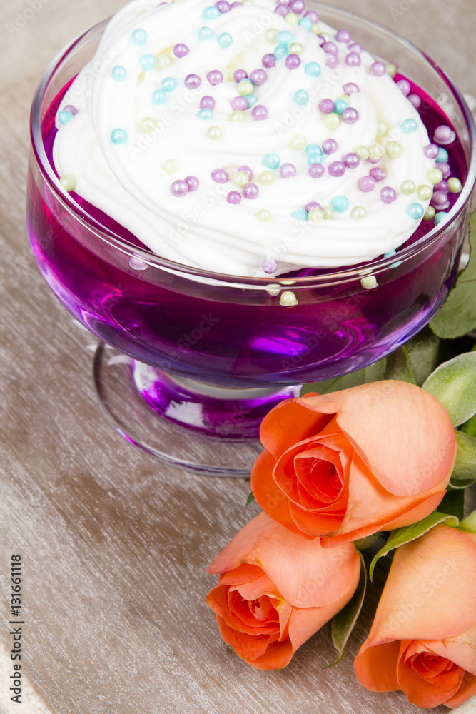 Colorful jelly with whipped cream and candy topping Colorful jelly with whipped cream and candy topping