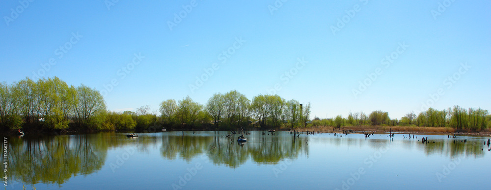 ON the lake in boats float fishermen over it. ON the lake in boats float fishermen