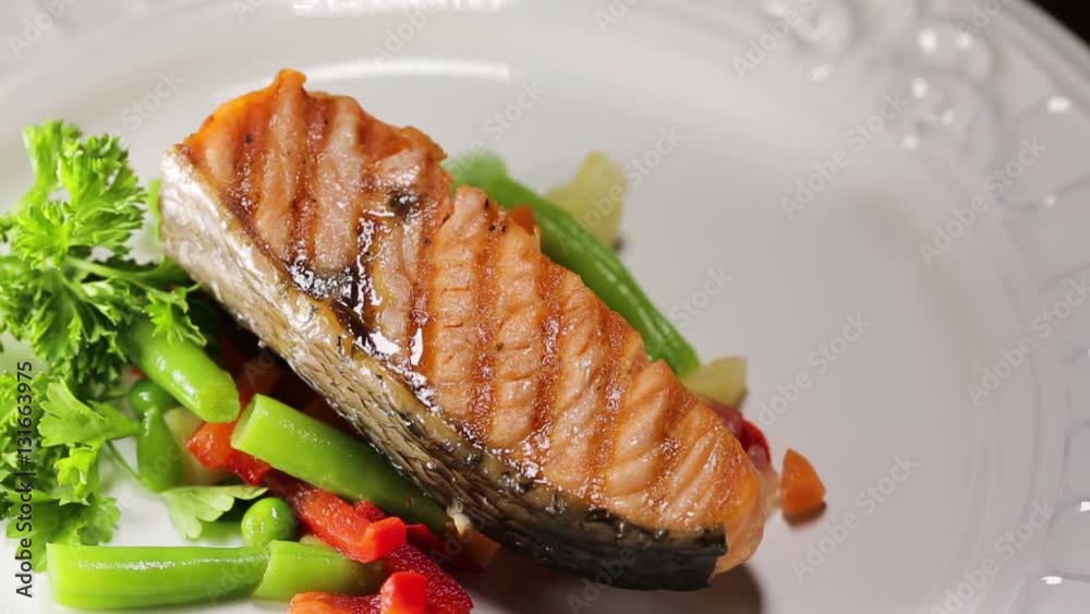 Put prepared grilled salmon fillets on the plate Put prepared grilled salmon fillets on the plate