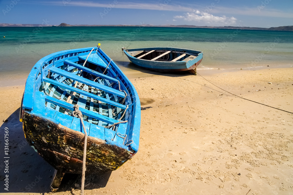 Blue boats on the shore