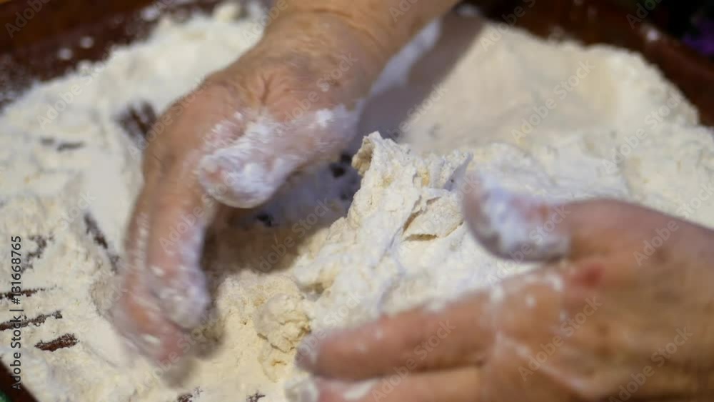 A family recipe, grandma's hands knead the dough for buns A family recipe, grandma's hands knead the dough for buns