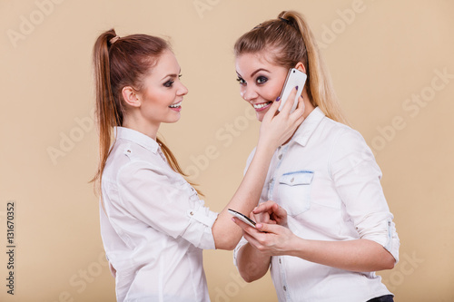 Girls using mobile phones talking reading message photo