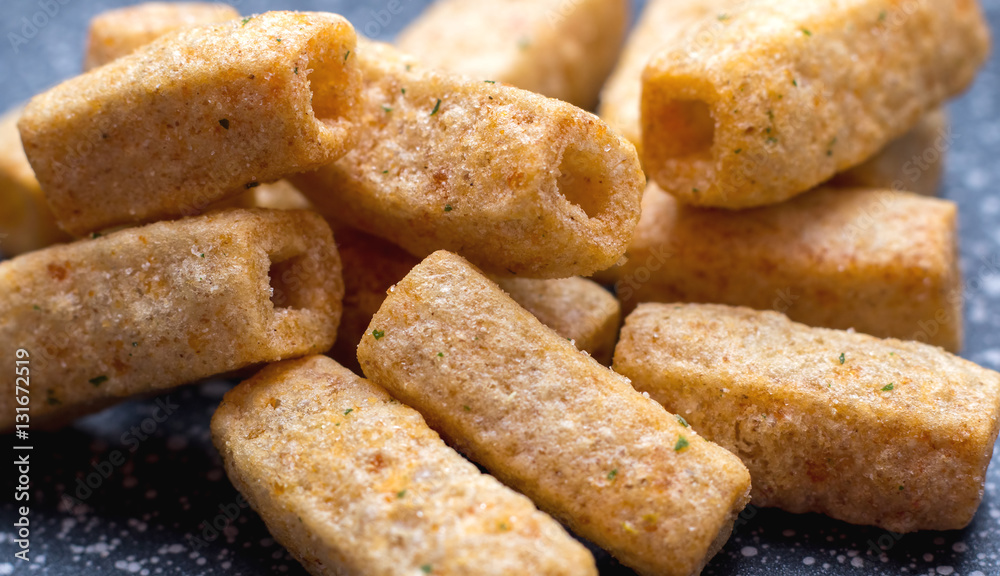 Chips of wheat flour in the form of tubes. Close-up Chips of wheat flour in the form of tubes. Close-up