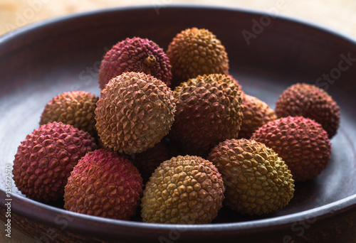 Healthy eating. Several lychee in an earthenware plate. photo