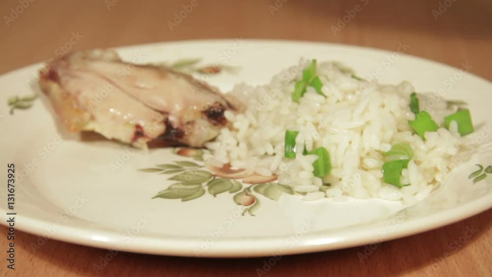 Man creates dishes portion from chicken wings with rice. Man creates dishes portion from chicken wings with rice.