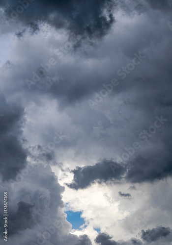 Beautiful dark clouds with a tiny blue clear cloudless part
