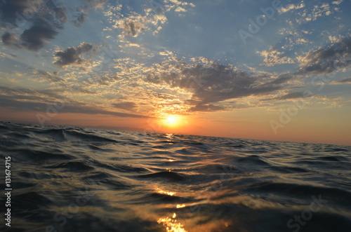 Stunning sunset on the waves sea with  a beautiful bright blue sky  with clouds or Caspian sea on the sunset