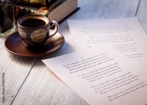 Books, coffee cup and poems on the old wooden table. Shakespeare Poems