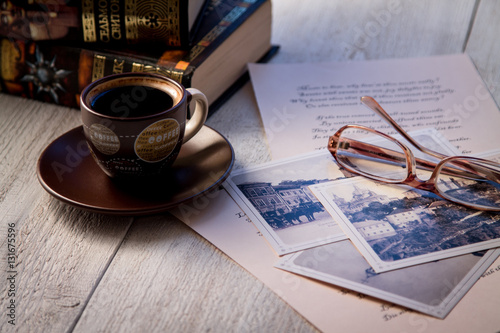 Books, coffee cup and poems on the old wooden table. Shakespeare Poems photo