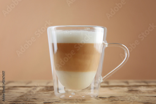 Cup of coffee on color background