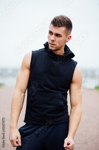 handsome young muscular sports man on city park background, posing, © photominus21
