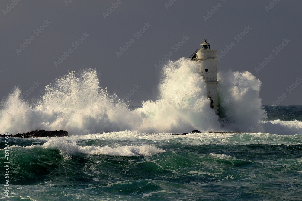 Mangiabarche Sardinia, Italy. Storm. Waves smash against lighthouse or beacon