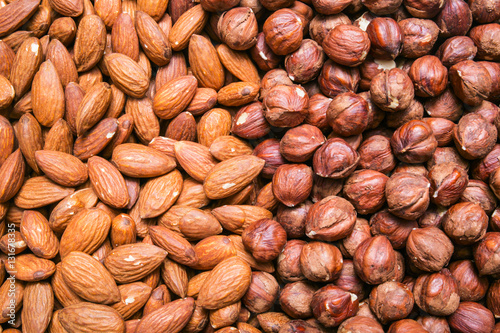Peeled almonds and hazelnuts background or texture