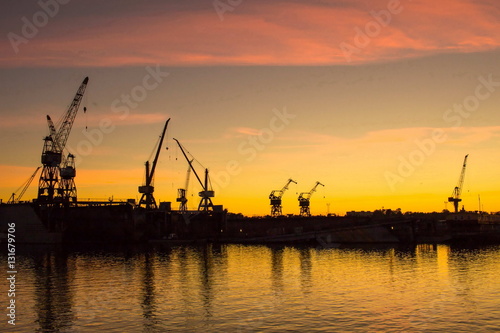 Cranes at sunset in port of Riga